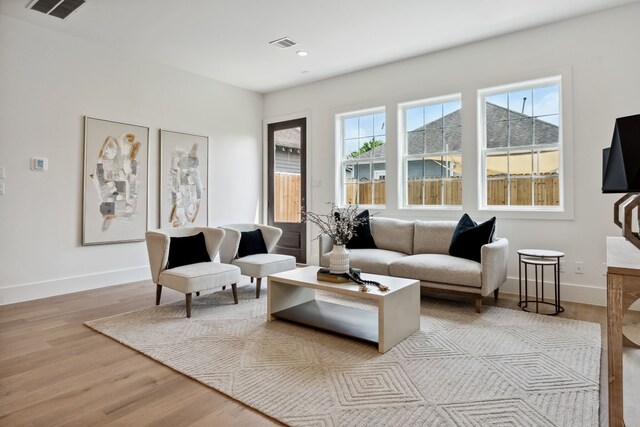 living area featuring wood finished floors, recessed lighting, and baseboards