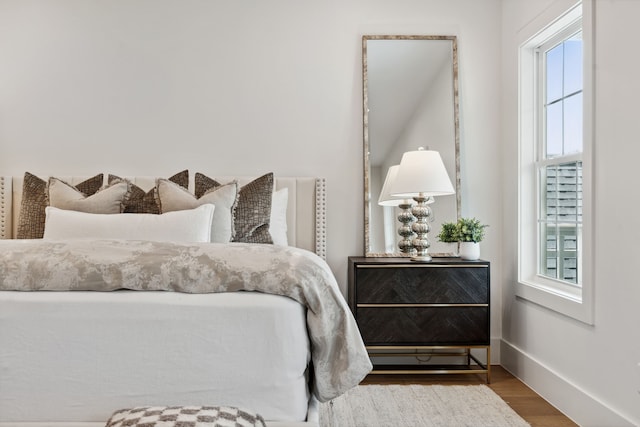 bedroom with wood finished floors and baseboards