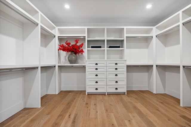 walk in closet with light wood-style floors