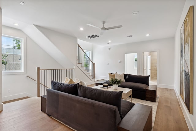 living area with a ceiling fan, light wood finished floors, recessed lighting, and baseboards