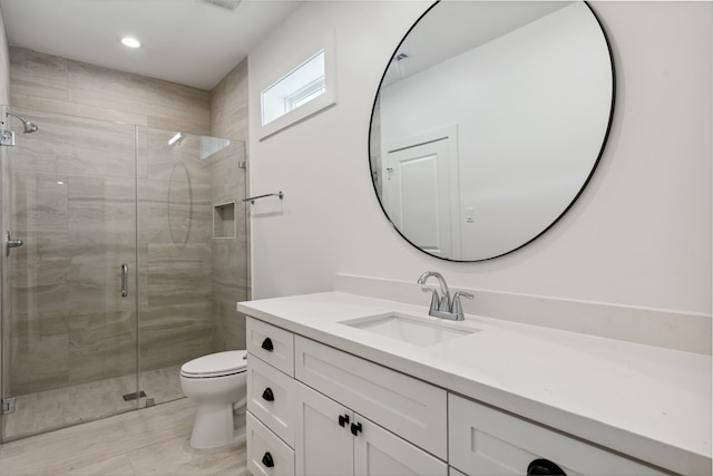 full bathroom featuring toilet, a shower stall, vanity, and recessed lighting