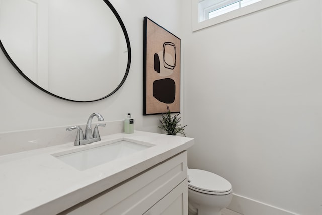 bathroom featuring toilet and vanity
