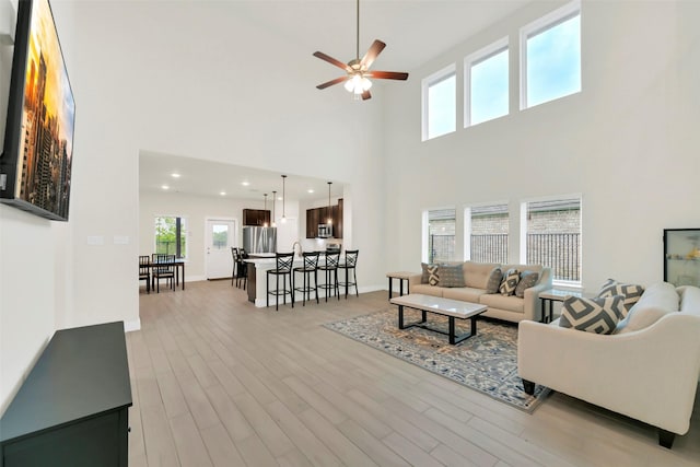 2108 Eagle Nook Dr, Texas City, TX 77568 - living area with a ceiling fan, a high ceiling, light wood-type flooring, recessed lighting, and baseboards