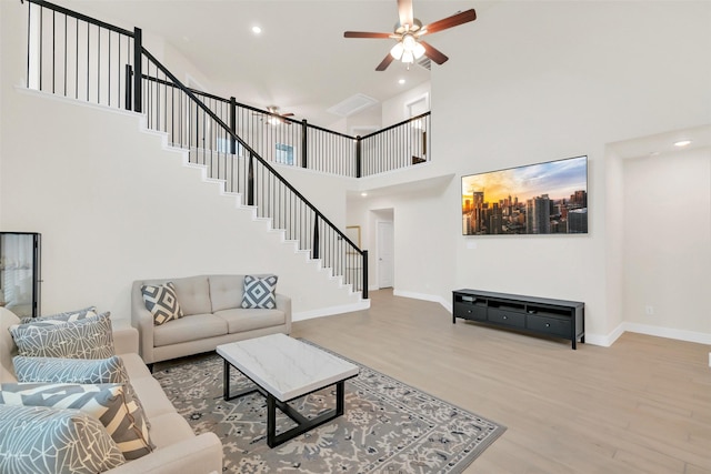2108 Eagle Nook Dr, Texas City, TX 77568 - living room with stairway, wood finished floors, ceiling fan, baseboards, and a towering ceiling