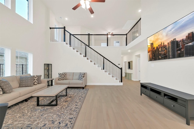 2108 Eagle Nook Dr, Texas City, TX 77568 - living room featuring a towering ceiling, plenty of natural light, stairway, and a ceiling fan