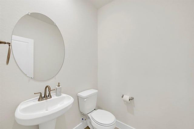 2108 Eagle Nook Dr, Texas City, TX 77568 - bathroom with a sink, baseboards, and toilet