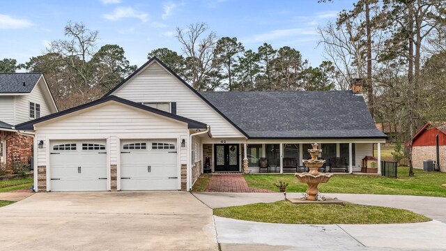 42 Cherry Hill Dr, Conroe, TX 77304 - traditional-style house with a garage, driveway, french doors, stone siding, and a chimney