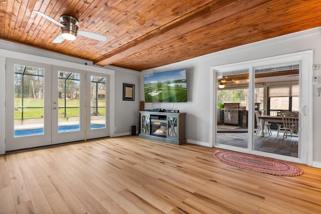 42 Cherry Hill Dr, Conroe, TX 77304 - unfurnished living room featuring wood finished floors, a ceiling fan, french doors, wooden ceiling with exposed beams, and baseboards