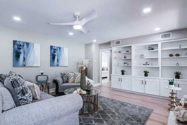 living room featuring wood finished floors, baseboards, ceiling fan, and recessed lighting