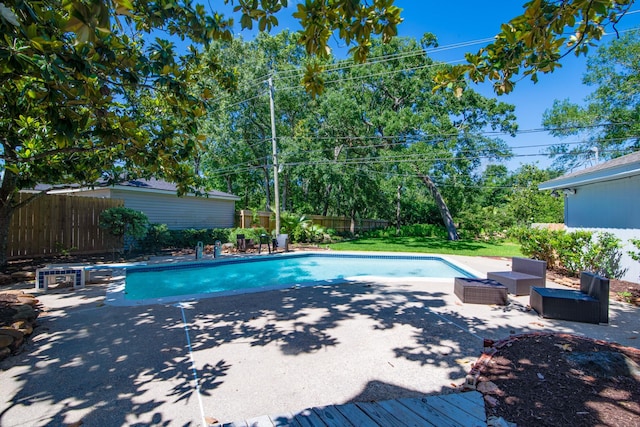 view of swimming pool with a patio, a fenced backyard, an outdoor hangout area, and a diving board