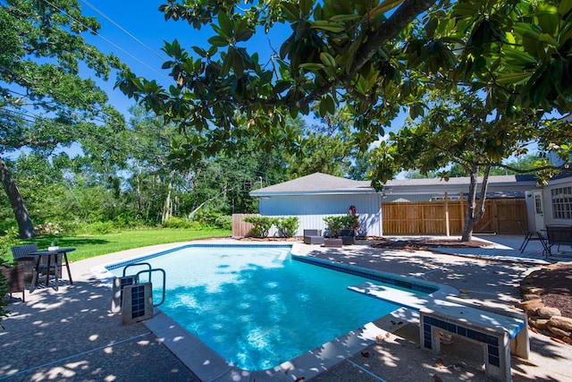 view of pool with a patio and fence