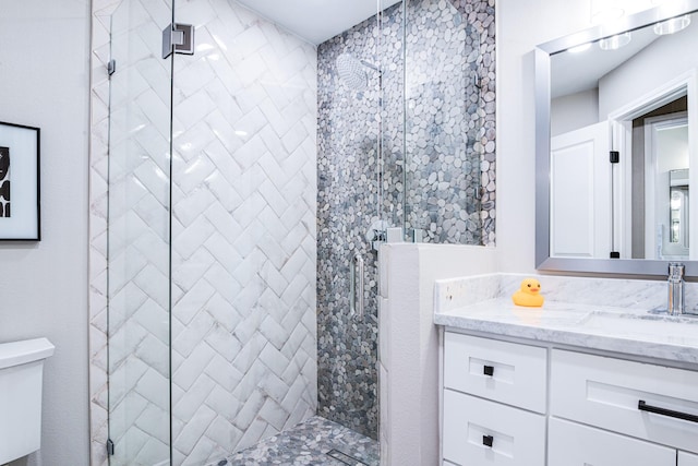 full bathroom with a stall shower, toilet, and vanity