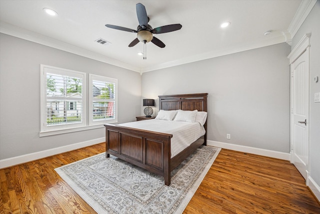bedroom featuring ornamental molding, wood finished floors, baseboards, a ceiling fan, and recessed lighting