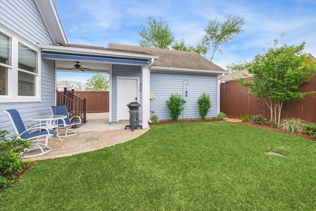 view of yard featuring a patio area and ceiling fan