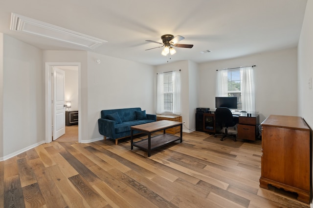 18910 S Sapling Oaks Pl, Magnolia, TX 77355 - home office featuring attic access, a ceiling fan, light wood finished floors, and baseboards