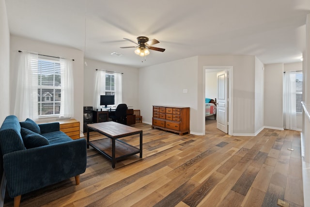 18910 S Sapling Oaks Pl, Magnolia, TX 77355 - living room featuring light wood-style flooring, ceiling fan, and healthy amount of natural light