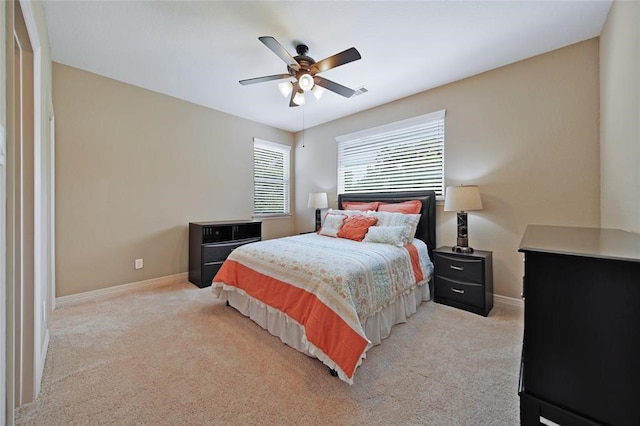 14710 Turquoise Ct, Willis, TX 77378 - bedroom featuring baseboards, light colored carpet, and a ceiling fan