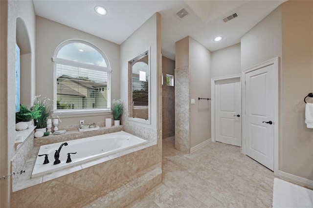 14710 Turquoise Ct, Willis, TX 77378 - bathroom with a bath, walk in shower, recessed lighting, and baseboards