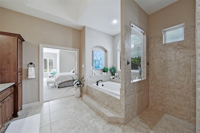 14710 Turquoise Ct, Willis, TX 77378 - ensuite bathroom featuring plenty of natural light, a bath, tile patterned floors, and a walk in shower