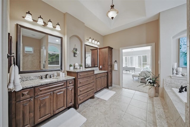 14710 Turquoise Ct, Willis, TX 77378 - full bath featuring healthy amount of natural light, two vanities, tile patterned floors, and a bathtub