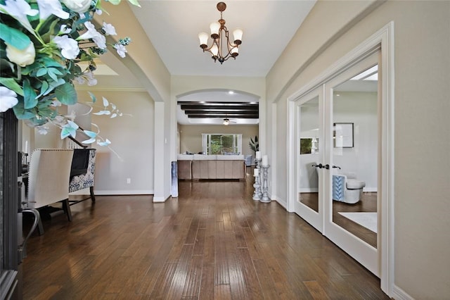 14710 Turquoise Ct, Willis, TX 77378 - entrance foyer with french doors, arched walkways, dark wood-type flooring, and a chandelier