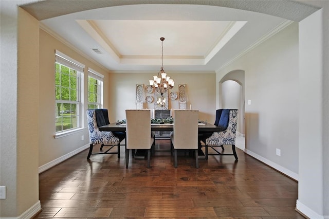 14710 Turquoise Ct, Willis, TX 77378 - dining room featuring arched walkways, a raised ceiling, hardwood / wood-style flooring, crown molding, and a chandelier