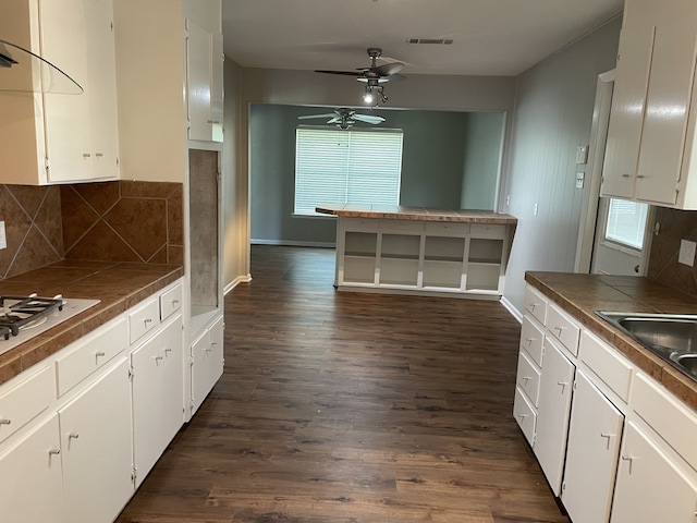 441 E Clark St, Bartlett, TX 76511 - kitchen featuring tile countertops, plenty of natural light, white cabinetry, and dark wood-style flooring