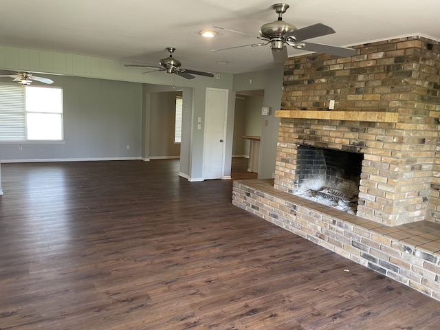 441 E Clark St, Bartlett, TX 76511 - unfurnished living room featuring ceiling fan, a fireplace, baseboards, and dark wood-style floors