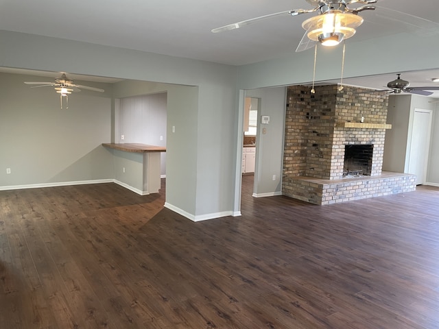 441 E Clark St, Bartlett, TX 76511 - unfurnished living room featuring ceiling fan, dark wood-type flooring, baseboards, and a fireplace