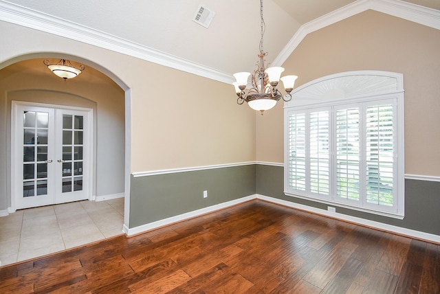8502 Calverton Pines Ln, Houston, TX 77095 - empty room with wood-type flooring, vaulted ceiling, arched walkways, a chandelier, and baseboards