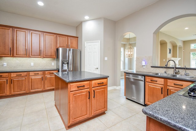 8502 Calverton Pines Ln, Houston, TX 77095 - kitchen with stainless steel appliances, a sink, brown cabinetry, and recessed lighting