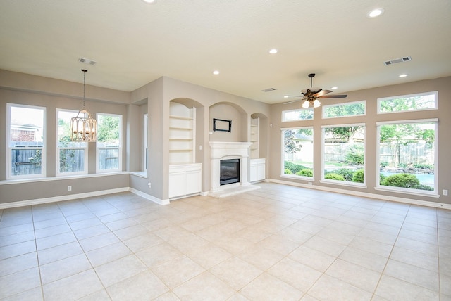8502 Calverton Pines Ln, Houston, TX 77095 - unfurnished living room with ceiling fan, recessed lighting, built in shelves, baseboards, and a glass covered fireplace