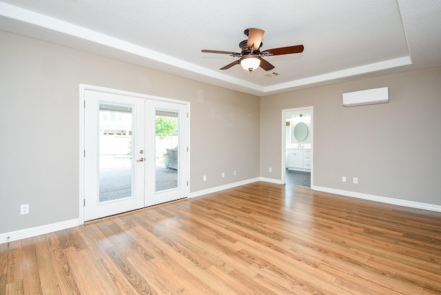 8502 Calverton Pines Ln, Houston, TX 77095 - empty room featuring a wall unit AC, french doors, ceiling fan, light wood finished floors, and baseboards
