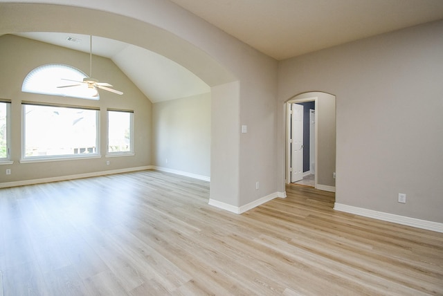 8502 Calverton Pines Ln, Houston, TX 77095 - empty room featuring healthy amount of natural light, a ceiling fan, arched walkways, light wood-style floors, and vaulted ceiling