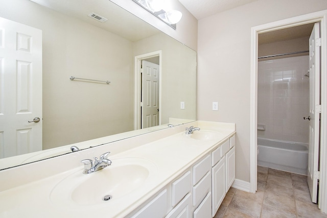 8502 Calverton Pines Ln, Houston, TX 77095 - bathroom featuring double vanity, baseboards, bathing tub / shower combination, and tile patterned floors