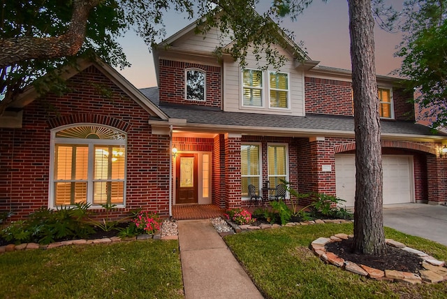 8502 Calverton Pines Ln, Houston, TX 77095 - view of front of property featuring covered porch, brick siding, a garage, driveway, and a yard