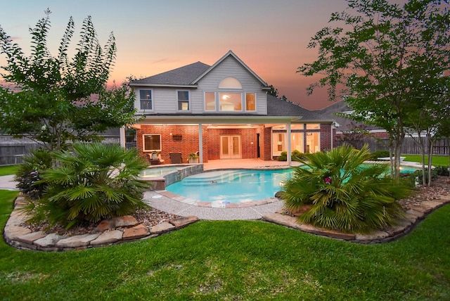 8502 Calverton Pines Ln, Houston, TX 77095 - rear view of property featuring brick siding, french doors, a pool with connected hot tub, a patio area, and a shingled roof