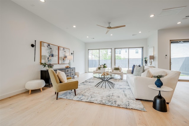 living room with wood finished floors, recessed lighting, a ceiling fan, and baseboards