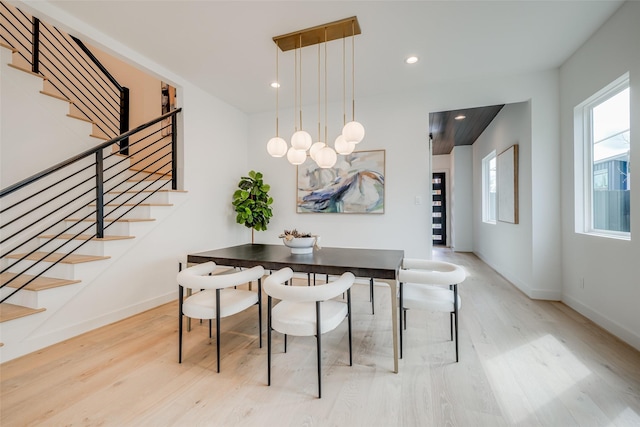 dining room with wood finished floors, stairway, baseboards, and recessed lighting