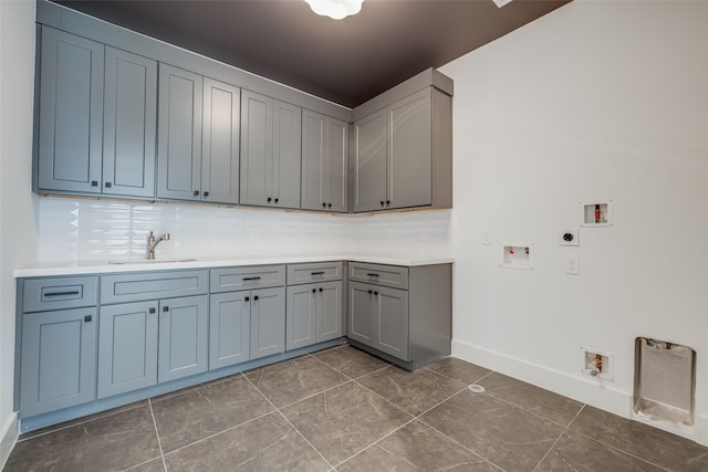 washroom featuring washer hookup, hookup for an electric dryer, cabinet space, and baseboards
