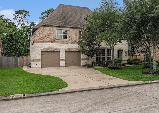 french provincial home featuring stone siding, an attached garage, concrete driveway, brick siding, and a shingled roof