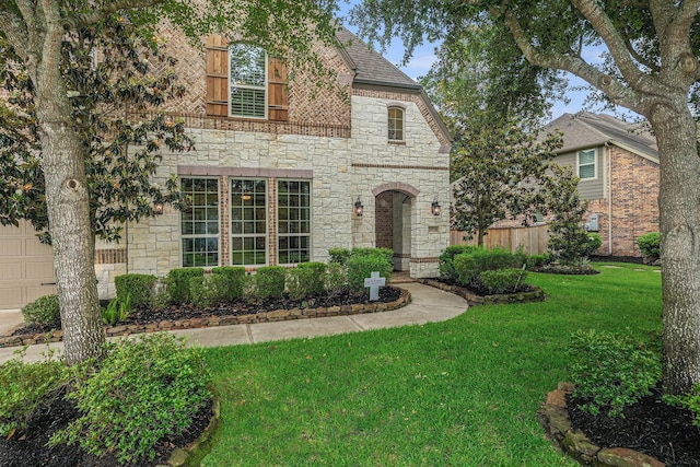 view of front of home with stone siding and a front yard