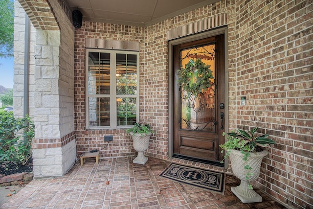 property entrance with brick siding