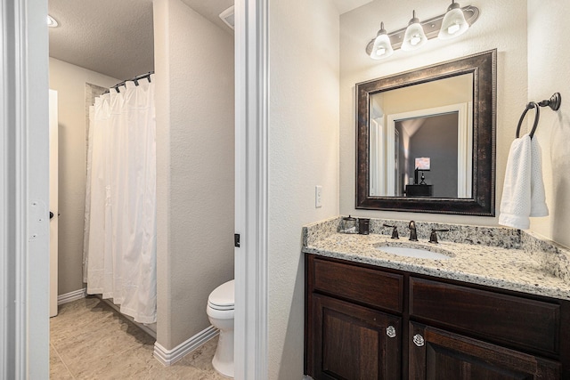 bathroom featuring vanity, toilet, a shower with curtain, and baseboards