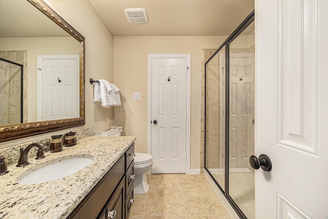 full bath with a stall shower, vanity, and toilet