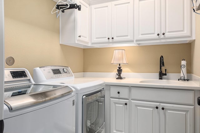 laundry room featuring cabinet space and washing machine and dryer