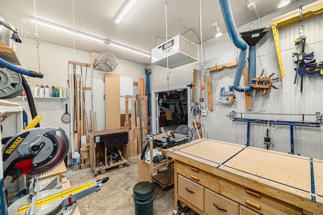 garage featuring a workshop area and a heating unit