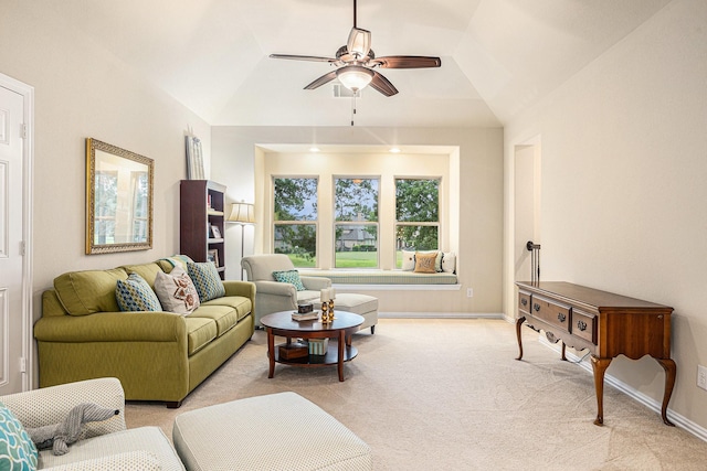 living room with a ceiling fan, light colored carpet, baseboards, and vaulted ceiling
