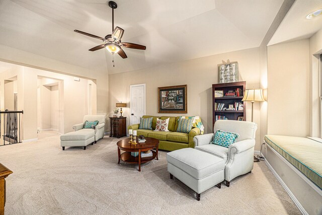 living area with carpet, a ceiling fan, and baseboards