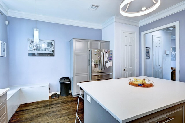 5507 Darling St, Houston, TX 77007 - kitchen with stainless steel refrigerator with ice dispenser, dark wood finished floors, crown molding, and light countertops